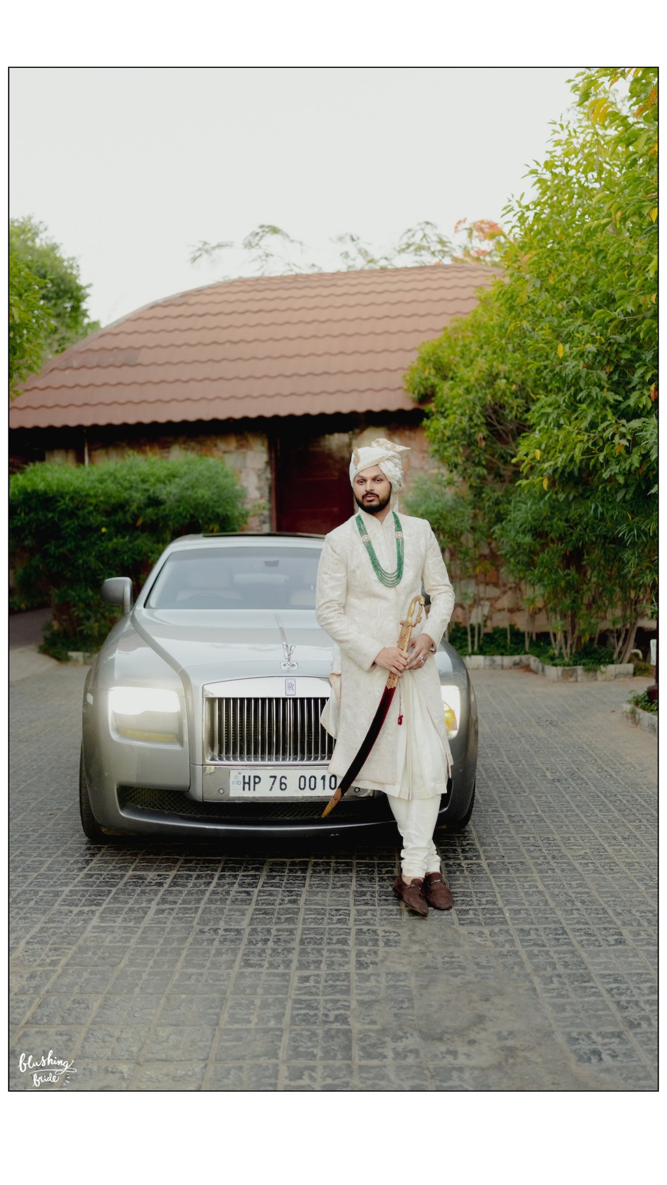 Groom in sherwani standing beside the wedding car in Patna